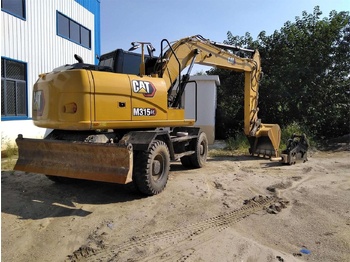 Grävmaskin på däck CATERPILLAR M315